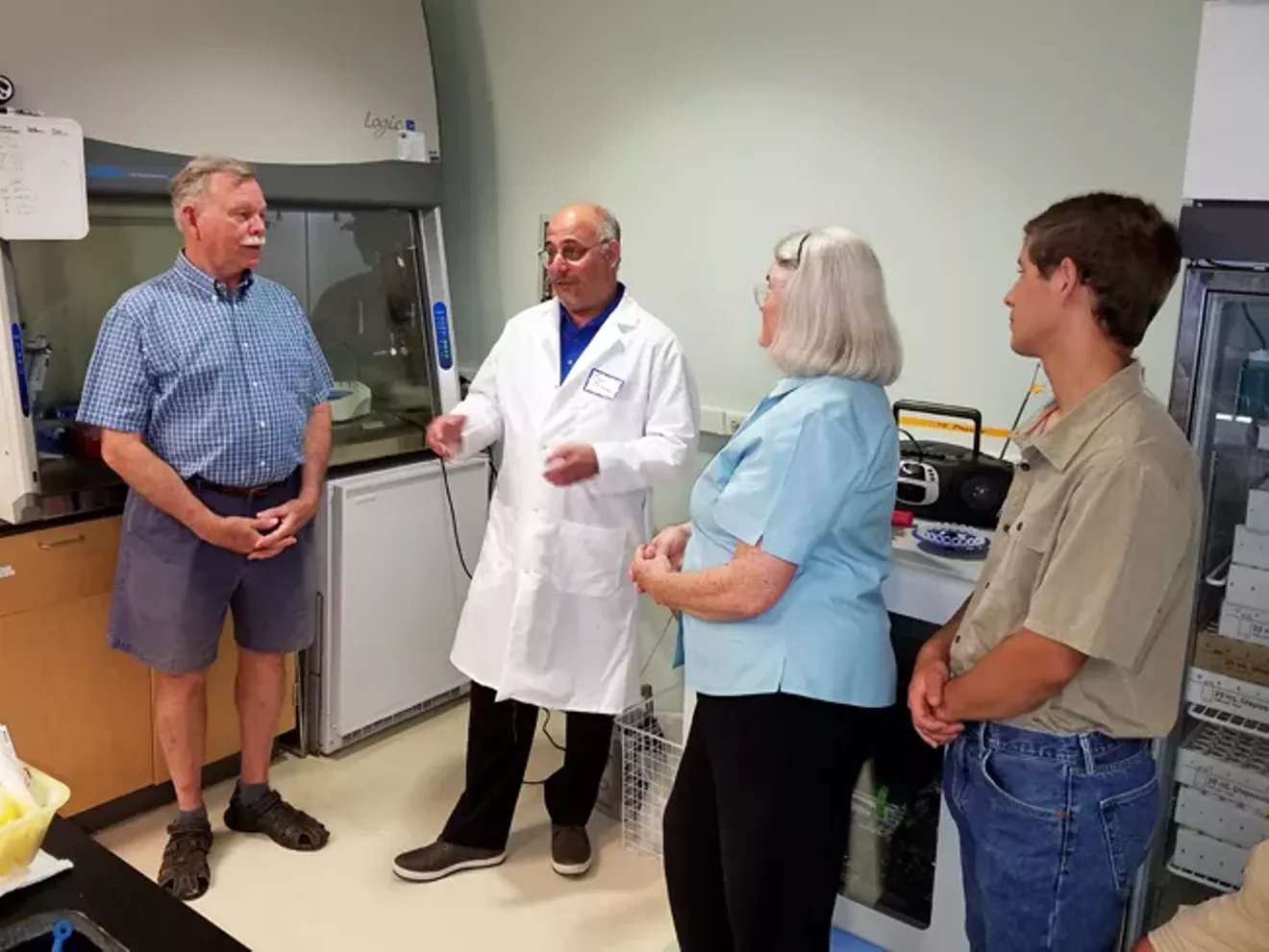 UGA Skidaway Institute scientist Marc Frischer (white coat) discusses his research with visitors at a 2018 Open Lab Night.