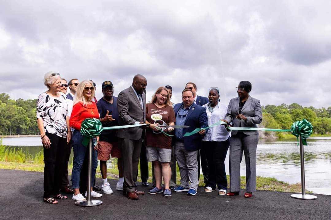 Michelle Mulvehill (with scissors in middle) at a ribbon cutting for Tribble Park on May 31, 2023