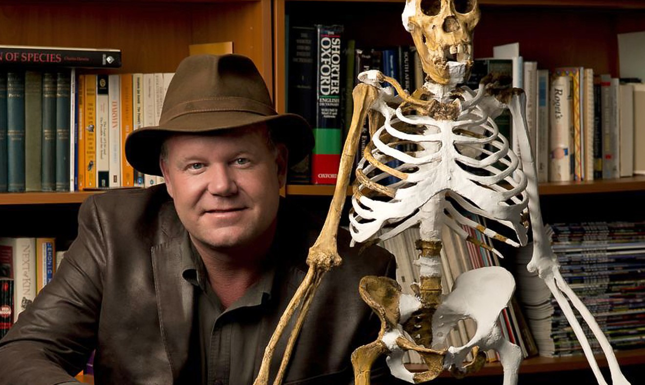 Professor Lee Berger with the reconstructed skeleton of Australopithecus sediba (adult female). Photo by Brett Eloff
