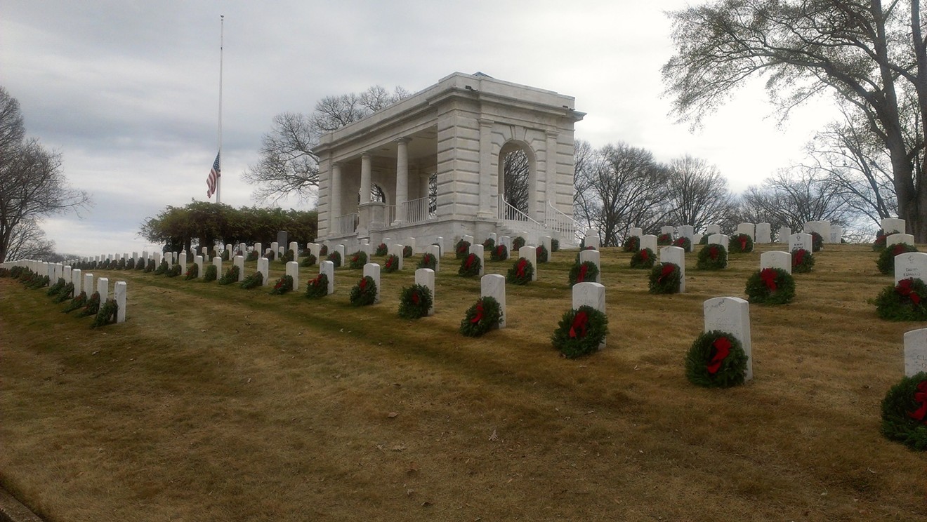 The American flag and a Prisoner of War/Missing in Action flag wave over the Marietta National Cemetery on a previous year’s Wreaths Across America Day in December.
