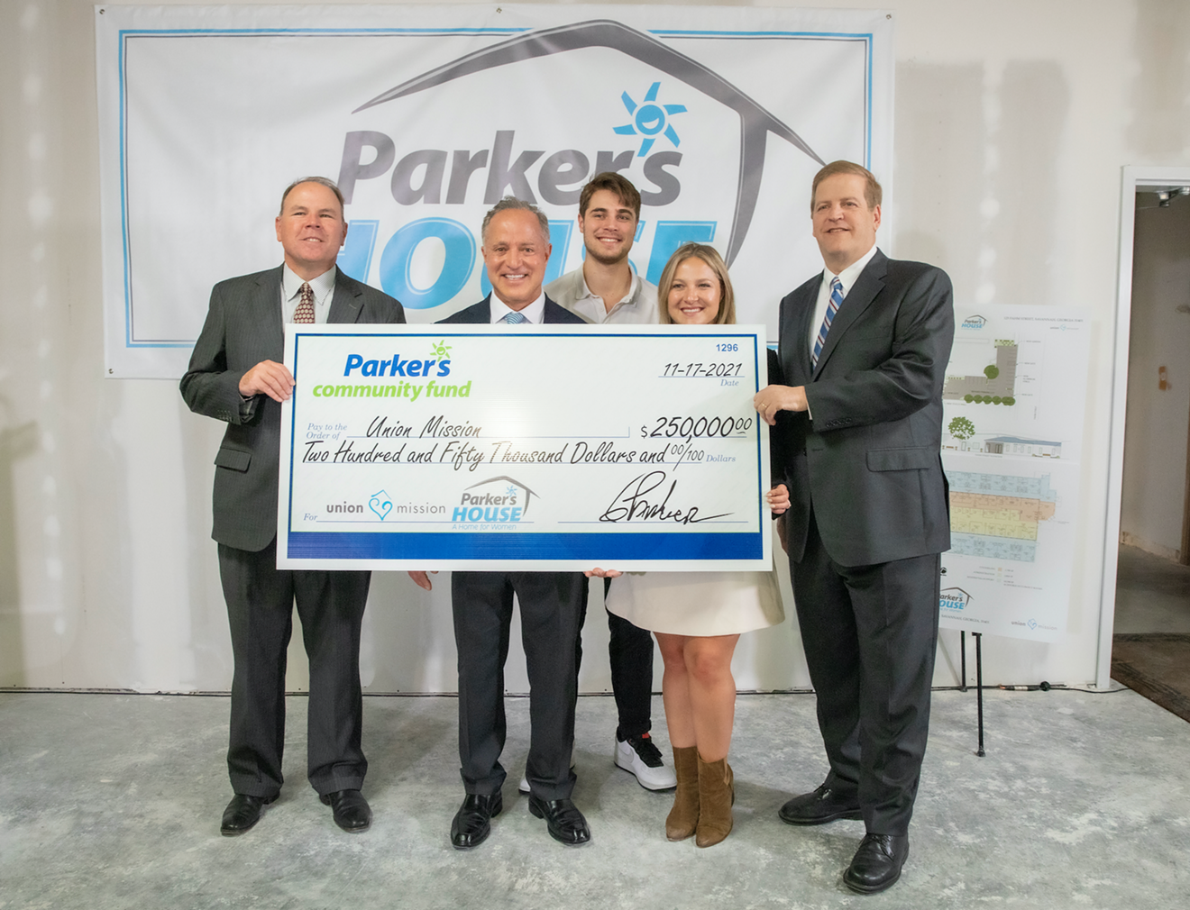 Parker's founder and CEO Greg Parker, Bennett Parker and Olivia Parker (second from left, center and second from right) presented a Parker's Community Fund check for $250,000 to Union Mission to create Parker's House, the only facility dedicated to unaccompanied women experiencing homelessness in coastal Georgia, on Nov. 17. Union Mission Board Chair Michael McCarthy, left, and Union Mission President and CEO Michael Traynor, right, accepted the donation on behalf of Union Mission. The facility, which is currently being renovated, will open in the first quarter of 2022 and will feature emergency housing for 32 women plus comprehensive on-site support services in Savannah.